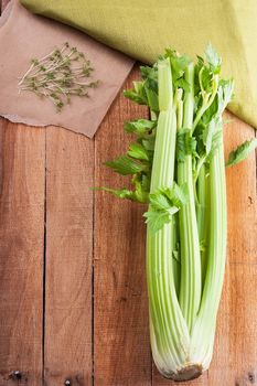 Bunch celery and salad crees on the on light wooden background