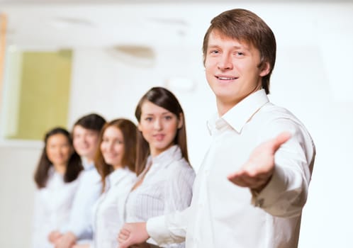 group of people holding hands, man holds out his hand, the concept of teamwork