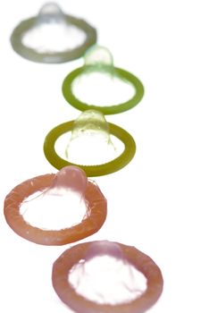 a narrow depth of field view of some colourful condoms