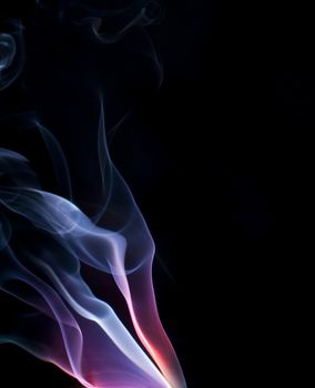 colorful purple and blue lit smoke on a black background