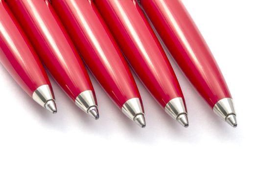 Red pens closeup on white background