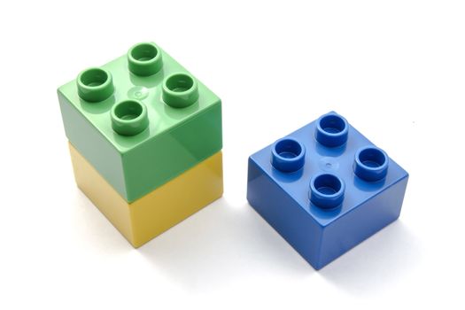 Colorful building blocks closeup on white background