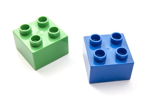 Colorful building blocks closeup on white background 