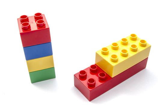Colorful building blocks closeup on white background