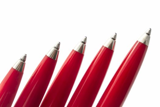 Red pens closeup on white background