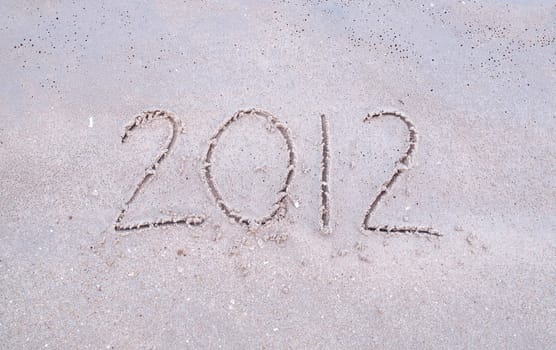 Handwritten message for year 2012 on tropical beach