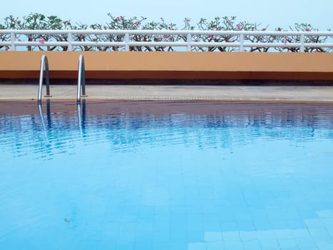 Swimming pool with blue water on terrace of condominium