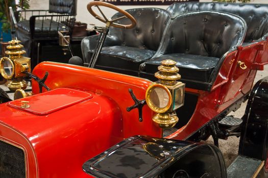 Classic Old Vintage Car in bright red color and golden items