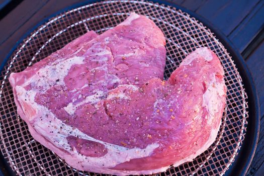 Closeup of a juicy steak made on a charcoal BBQ grill 