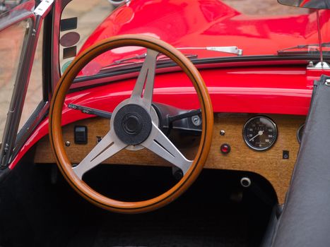 Interior and dashboard detail of a restored retro soft-top famous classical sports car 