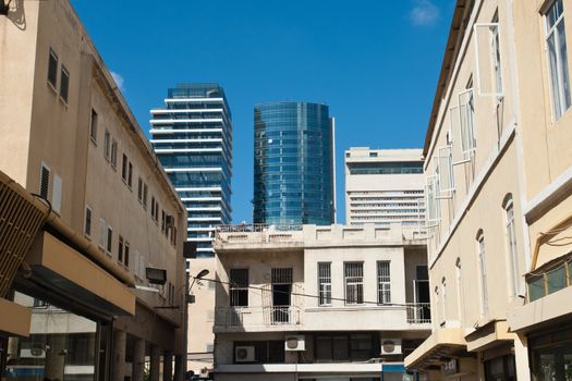 Old and new architecture modern skyscraper and traditional style house downtown Tel Aviv Israel