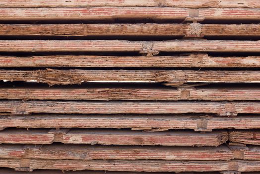 Stacked used red form boards with chips and brackets