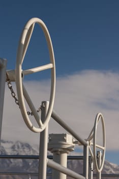 wheels for opening and closing valves against blue and cloudy sky