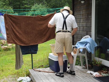 Country gentleman washing his clothes on wash day.