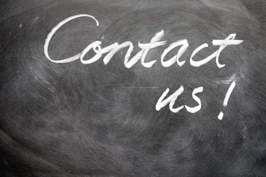 Contact us written with chalk on blackboard