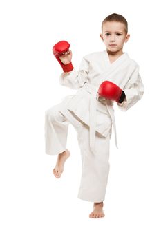 Martial art sport - child boy in white kimono training karate punch or kick