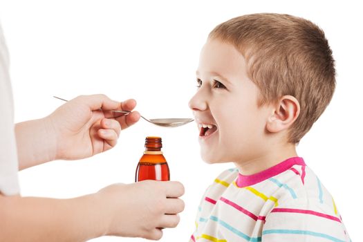 Doctor hand giving spoon dose of medicine liquid drinking syrup to child boy patient