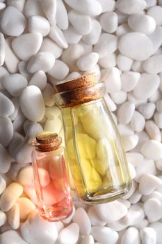 bottles of the massage oil on white stone