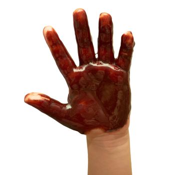 Small children's hand soiled with chocolate glaze