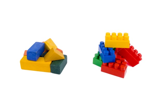 Colourful wooden and plastic bricks on white background