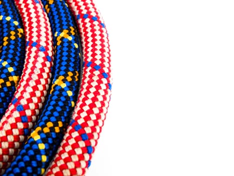 Closeup picture of climbing rope on white background. On the right side of picture it's empty white space.