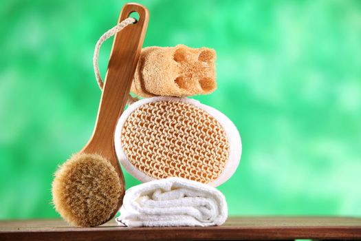 brush ,span,loofah and the towel on the green background