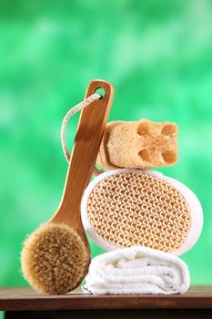 brush ,span,loofah and the towel on the green background
