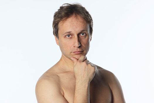 Portrait of a pensive middle age man with naked shoulder