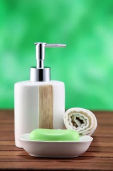 soap and dispenser  on the wooden table top