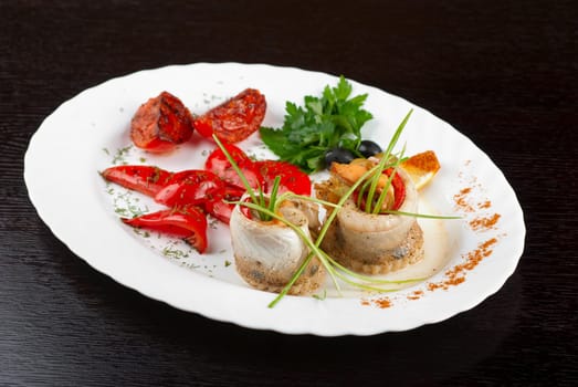 fillet of pikeperch stuffed with trout fish with baked pepper, tomato and leek