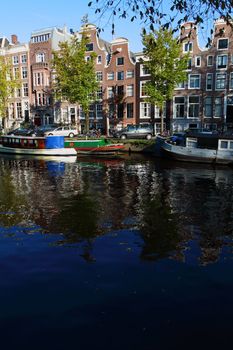 Quiet Amsterdam canal with house boats 