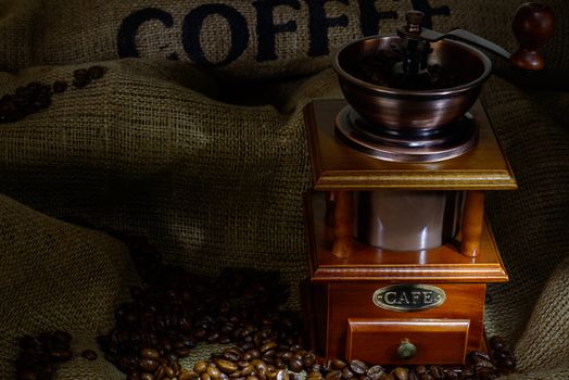 Coffee Mill with beans and burlap. still life