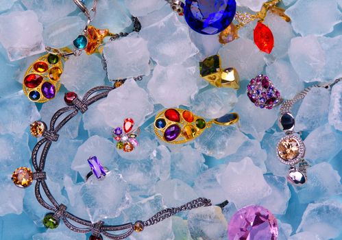 Jewels at blue cube of ice background