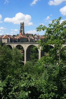 Photo of the bridge and church tower in Fribourg, Switzerland.