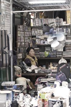 HONG KONG - 17 DEC, A Chinese hawker is selling electric appliances and other accessories in Ap Liu Street, Hong Kong on 17 December, 2011. It is one of the famous street in Hong Kong.