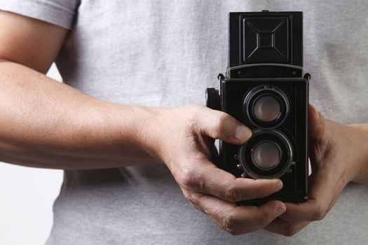 stock image of the unrecognisable people holding a antique camera