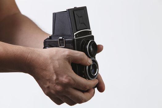 stock image of the unrecognisable people holding a antique camera