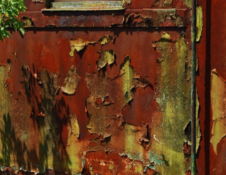 Rusty wagon surface with blistered paint coat