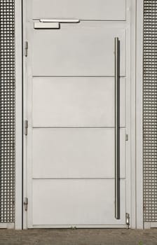 The door cover is divided into four rectangles. Long vertical handle. Metal everywhere.
