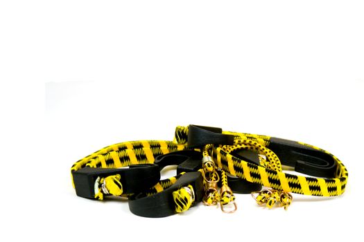 Isolated Bungee Cords which are Yellow and Black isolated on a white background
