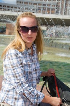 Girl near city fountain. Astana, August 2007