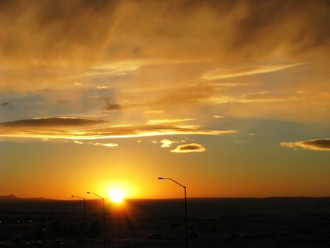 Solar is the Future of Electric Power captures the essence of the street lights with contratsed by the power and magnitude of the setting sun over a Colorado Sky.