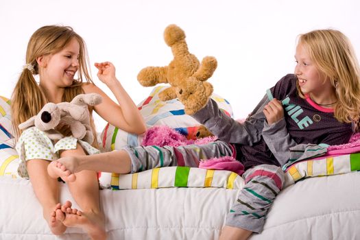 Two young children enjoying their colorful bed