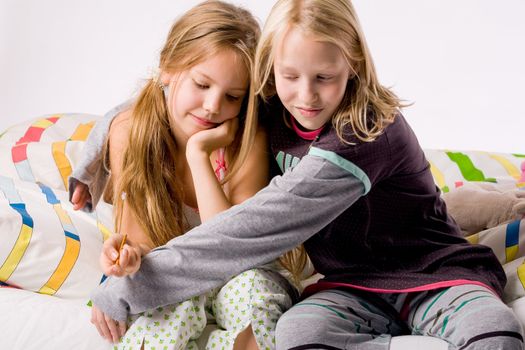 Two young children enjoying their colorful bed