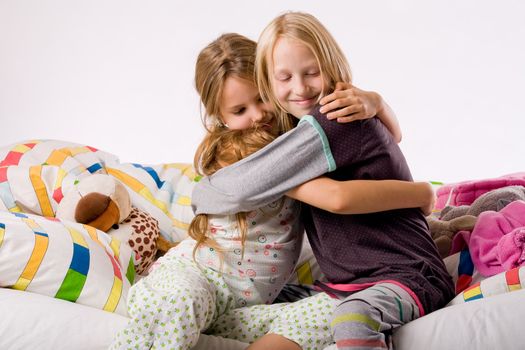 Two young children enjoying their colorful bed