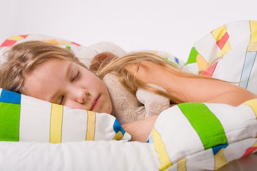 Sleeping young cute child in a colorful bed