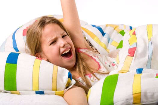 Sleeping young cute child in a colorful bed