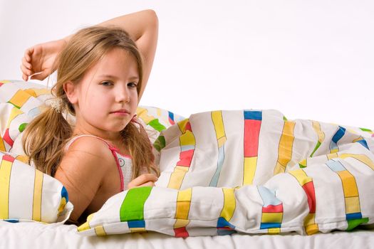 Sleeping young cute child in a colorful bed