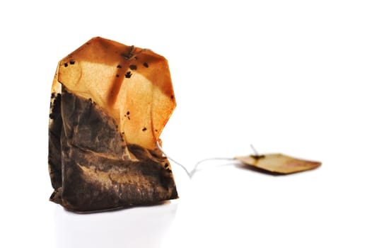 Squeezed tea bag on white background