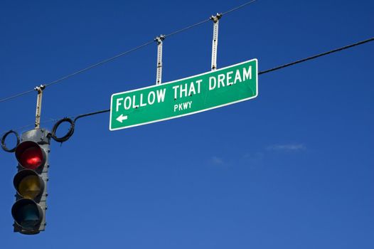 A street sign tells you to Follow That Dream.